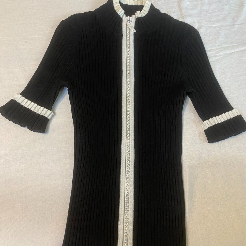 black zip up mid sleeve top with bedazzled zipper, and rib knit material
